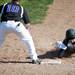 Huron Victor Phillips slides back onto first after leading off on Monday, May 13. Daniel Brenner I AnnArbor.com